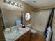 Bright bathroom with a tub, a sink with cabinet storage, and a small window at 326 Lander Dr, Henderson, NV 89074