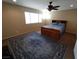 Cozy bedroom featuring a large bed, area rug, and a ceiling fan for added comfort at 326 Lander Dr, Henderson, NV 89074