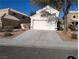 Home featuring desert landscaping, long driveway, and a two-car garage at 326 Lander Dr, Henderson, NV 89074