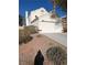 Home showcasing desert landscaping, two-car garage and interesting architecture at 326 Lander Dr, Henderson, NV 89074