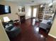 Bright living room featuring hardwood floors, fireplace, built-in shelves, comfortable chairs, and modern decor at 326 Lander Dr, Henderson, NV 89074