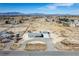 Expansive aerial view of a single-story home, garage, desert landscape, and mountain backdrop at 3420 Malibou Ave, Pahrump, NV 89048