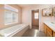 Bright bathroom featuring a large soaking tub under a window, creating a relaxing atmosphere at 3420 Malibou Ave, Pahrump, NV 89048