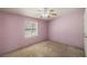 Bedroom featuring neutral carpet, a ceiling fan, and a window at 3420 Malibou Ave, Pahrump, NV 89048