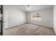 This carpeted bedroom has a ceiling fan and window that provides natural light and ventilation at 3420 Malibou Ave, Pahrump, NV 89048