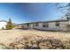 Single-story home with a porch and desert landscaping under a clear blue sky at 3420 Malibou Ave, Pahrump, NV 89048