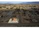 Vast aerial view of desert community with a single Gathering home with desert landscaping at 3430 Flagstone Ct # 2, Pahrump, NV 89048