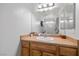 Bathroom featuring a wood vanity with white sink and a large mirror, offering ample lighting at 3430 Flagstone Ct # 2, Pahrump, NV 89048