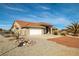 Inviting single-story home featuring a two-car garage and a low-maintenance xeriscape front yard with gravel at 3430 Flagstone Ct # 2, Pahrump, NV 89048
