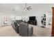 Spacious living room featuring a ceiling fan, gray sofas, and neutral carpeting at 3430 Flagstone Ct # 2, Pahrump, NV 89048