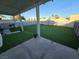 Backyard features green turf, concrete patio, perimeter fence, and covered patio at 3550 Leor Ct, Las Vegas, NV 89121