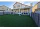 Wide angle exterior view of backyard and covered patio with furniture and green turf at 3550 Leor Ct, Las Vegas, NV 89121