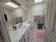 Bathroom featuring a single sink vanity and a tub-shower combo with a glass door at 3550 Leor Ct, Las Vegas, NV 89121