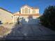 Charming two-story home featuring a terracotta roof, arched windows, and a two-car garage at 3550 Leor Ct, Las Vegas, NV 89121