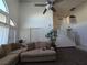 Bright living room featuring large windows, a vaulted ceiling, and neutral-toned furniture at 3550 Leor Ct, Las Vegas, NV 89121