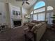 Inviting living room featuring a cozy fireplace, plush seating, and a large window at 3550 Leor Ct, Las Vegas, NV 89121