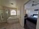 Primary bathroom featuring a jetted tub, tiled shower, and entrance to the primary bedroom at 3550 Leor Ct, Las Vegas, NV 89121