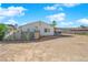 View of the home's backyard, showing the exterior wall and desert landscaping at 3936 Savoy Ct, Las Vegas, NV 89115