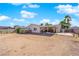 Wide backyard with a desert landscape with a covered patio structure visible in the distance at 3936 Savoy Ct, Las Vegas, NV 89115