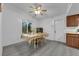 Traditional dining room with wooden table set, fan lighting, and light grey wood-look flooring at 3936 Savoy Ct, Las Vegas, NV 89115