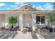 Close up view of front entrance featuring desert landscaping, covered entry, and a large window at 3936 Savoy Ct, Las Vegas, NV 89115