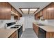 Kitchen featuring wood cabinets, laminate countertops, and modern appliances at 3936 Savoy Ct, Las Vegas, NV 89115