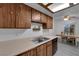 Kitchen with wood cabinets, laminate countertops, stainless steel sink and dining area at 3936 Savoy Ct, Las Vegas, NV 89115