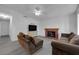 Bright living room featuring a brick fireplace, modern ceiling fan, and neutral paint at 3936 Savoy Ct, Las Vegas, NV 89115