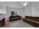 Cozy living room with a brick fireplace, ceiling fan and neutral paint at 3936 Savoy Ct, Las Vegas, NV 89115