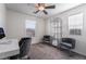 Bright bedroom with a ceiling fan, desk, and stylish gray chairs at 406 Misterioso St, Henderson, NV 89011