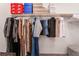 Well-organized closet with clothes on hangers and boxes on the upper shelf at 406 Misterioso St, Henderson, NV 89011