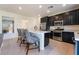 Modern kitchen featuring stainless steel appliances, an island, and dark cabinetry at 406 Misterioso St, Henderson, NV 89011