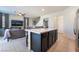 The kitchen island features barstool seating that looks out into the living room at 406 Misterioso St, Henderson, NV 89011