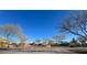 Community playground with play structures surrounded by trees at 406 Misterioso St, Henderson, NV 89011