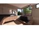 Tranquil bathroom with soaking tub, wood accents, and a large window overlooking greenery at 4317 Cameron Brook Ct, Las Vegas, NV 89129