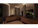 Elegant bathroom showcasing wood cabinets, dual sinks, and large mirrors with stylish lighting at 4337 Cameron Brook Ct, Las Vegas, NV 89129