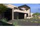 Modern home exterior with dark garage doors, stone accents, and desert-style landscaping at 4337 Cameron Brook Ct, Las Vegas, NV 89129