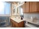 Bathroom vanity with cabinets, sink, and a window with blinds at 4746 Rosalie Cir, North Las Vegas, NV 89031