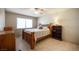 Cozy bedroom with tile flooring, a wooden bed frame, and a ceiling fan at 4746 Rosalie Cir, North Las Vegas, NV 89031