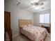 Comfortable bedroom features ceiling fan, window with blinds, tile floors, and bed with floral patterned bedding at 4746 Rosalie Cir, North Las Vegas, NV 89031