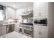 Modern kitchen featuring stainless steel appliances, sleek white cabinets, and granite countertops at 4746 Rosalie Cir, North Las Vegas, NV 89031