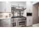 Close up of a large stainless steel range with white cabinets and granite countertops at 4746 Rosalie Cir, North Las Vegas, NV 89031