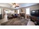 Living room with a fireplace, ceiling fan and views into the kitchen at 4746 Rosalie Cir, North Las Vegas, NV 89031