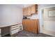 Neutral spare room with wood-look floors, white desk, overhead cabinets, and standard closet at 4746 Rosalie Cir, North Las Vegas, NV 89031