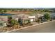 Overhead view of a home with desert landscaping, a tile roof, a two-car garage, and a serene golf course backdrop at 4775 E Beacon Ridge Dr, Pahrump, NV 89061