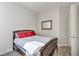 Bright bedroom featuring wood tile floors, a framed mirror, and ample natural light at 4775 E Beacon Ridge Dr, Pahrump, NV 89061