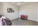 Bedroom with wood-look tile flooring, airplane wall art, and neutral colored walls at 4775 E Beacon Ridge Dr, Pahrump, NV 89061