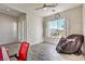 Bedroom features wood-look tile, neutral walls, bright window, and a modern ceiling fan at 4775 E Beacon Ridge Dr, Pahrump, NV 89061