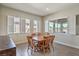 Dining room with a wooden table, wood chairs, and ample natural light from windows with shutters at 4775 E Beacon Ridge Dr, Pahrump, NV 89061