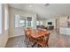 Bright dining room with a wooden table, wood chairs, and ample natural light from a large window at 4775 E Beacon Ridge Dr, Pahrump, NV 89061